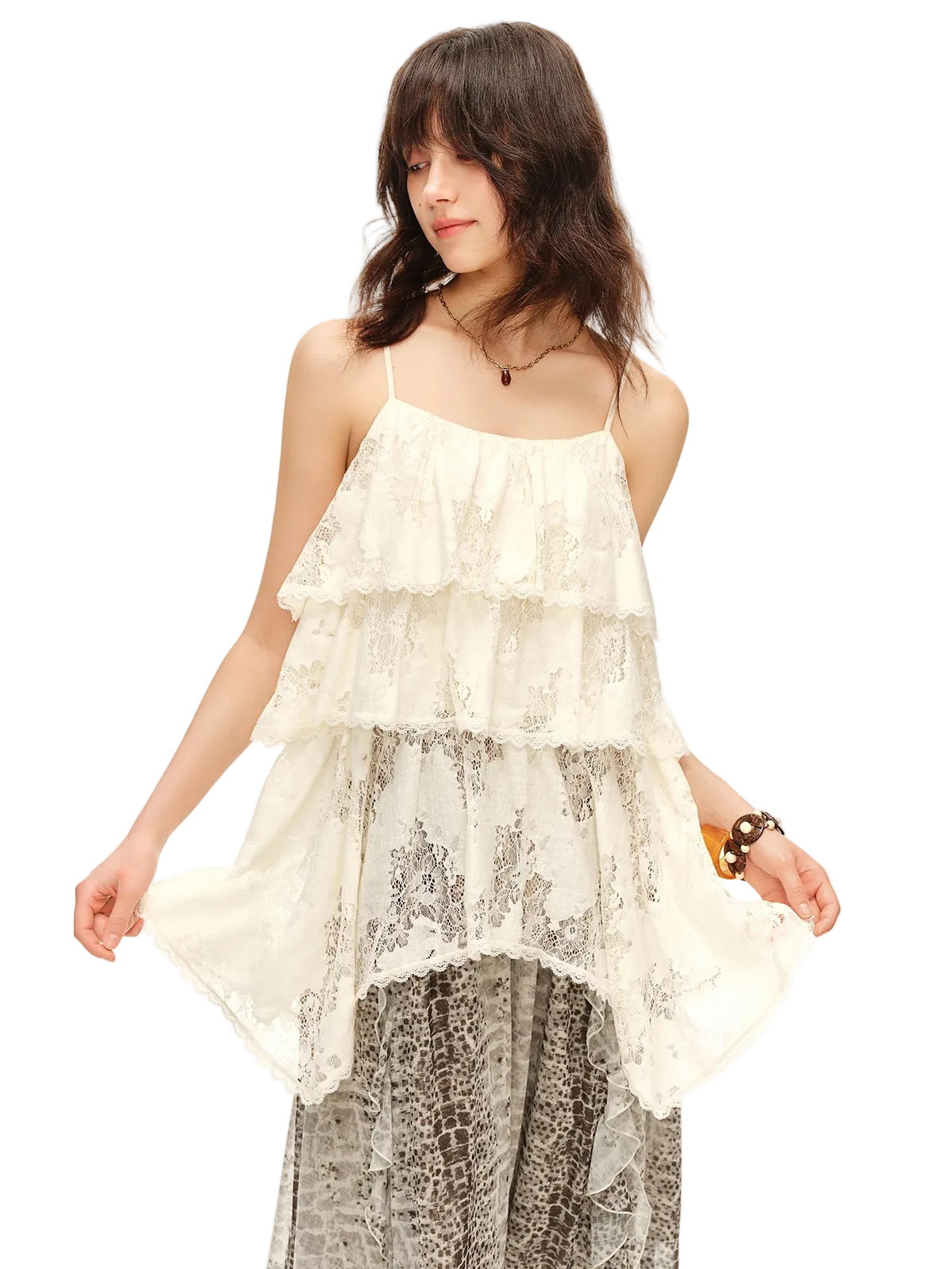 A woman wearing a cream lace tiered camisole top with spaghetti straps and a high-low hem, paired with patterned pants. The brand name 'Dushu' is printed in black in the top-left corner against a plain white background.