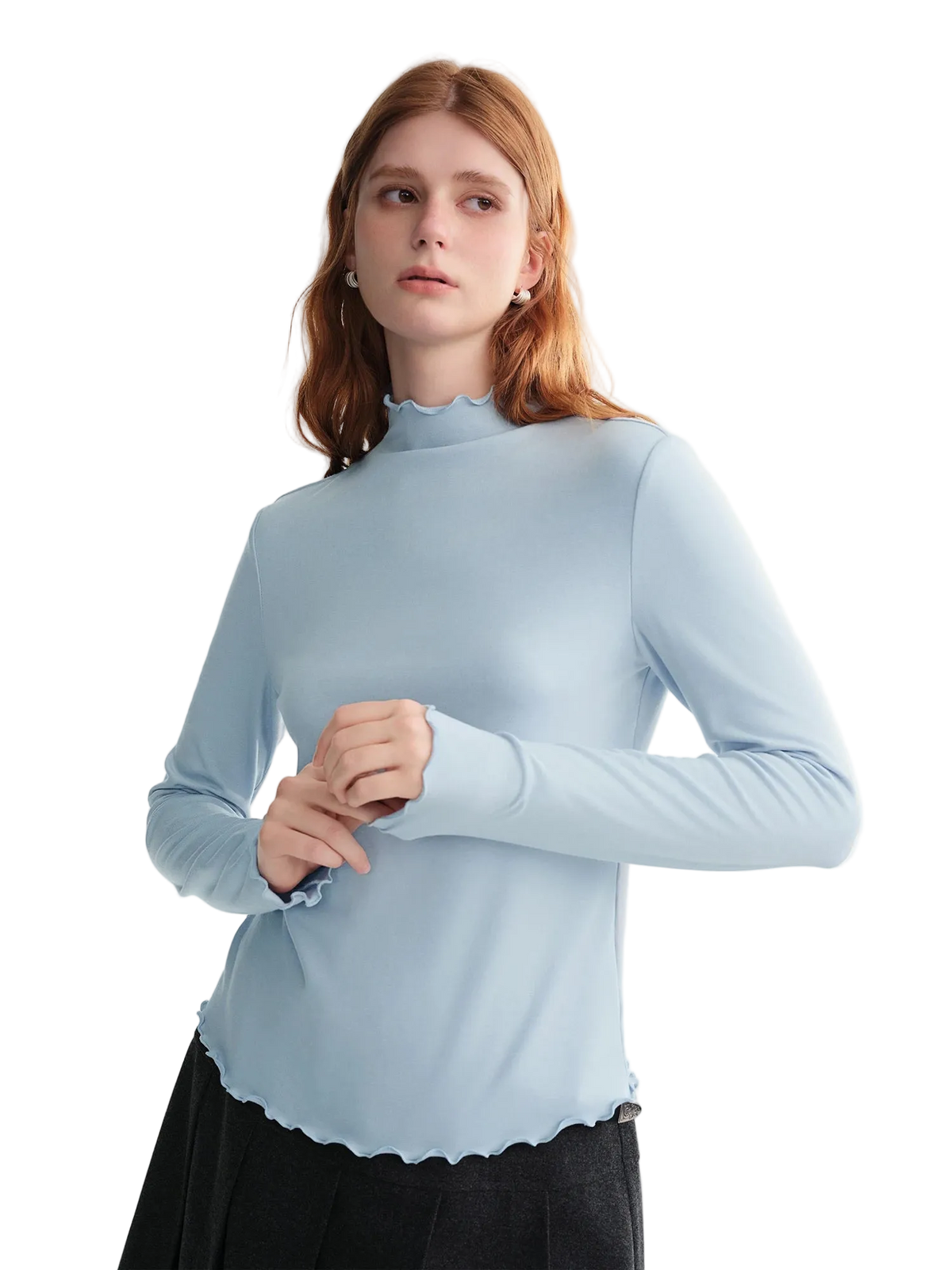 Woman wearing a light blue long-sleeve top against a white background